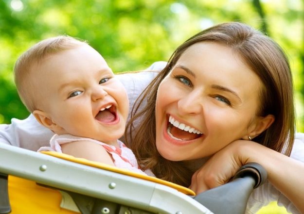 An aupair and a baby outdoors